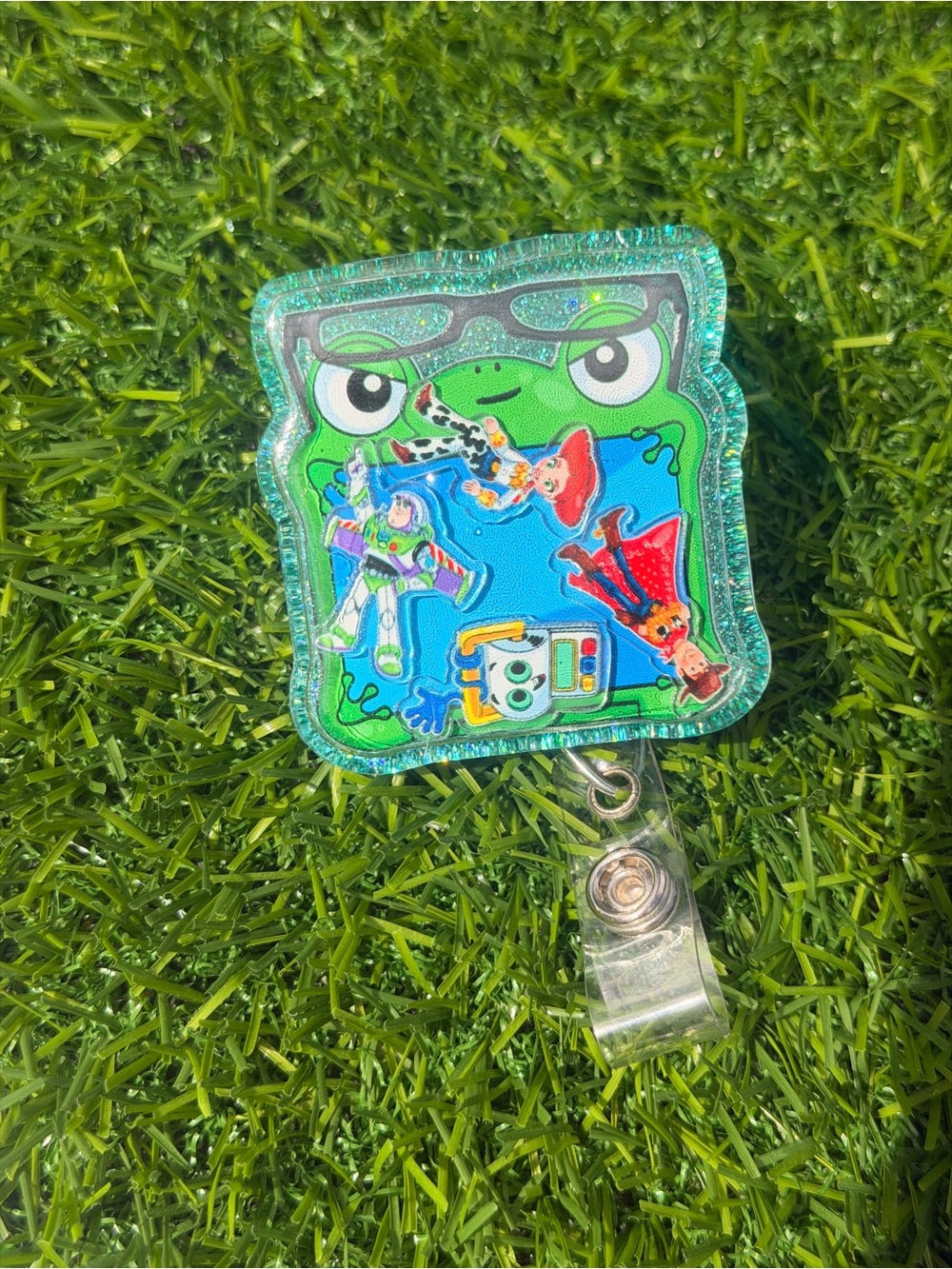 Green Frog Badge Reel with Colorful Toy Story Decals